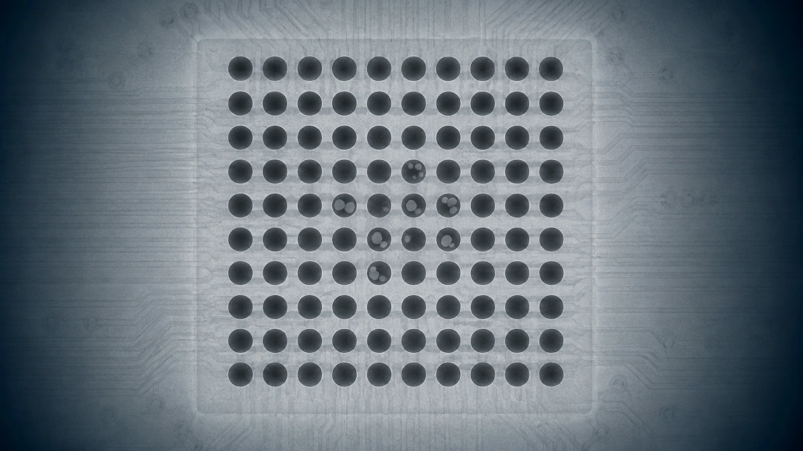 X-ray style BGA inspection showing lighter internal voids in several dark solder balls